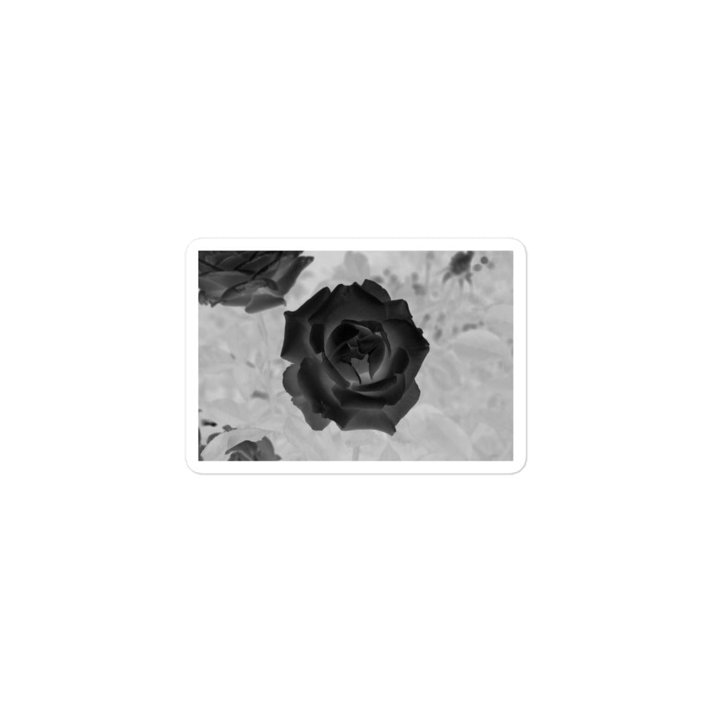 A small rectangular vinyl sticker with an image of a black x-ray rose design.