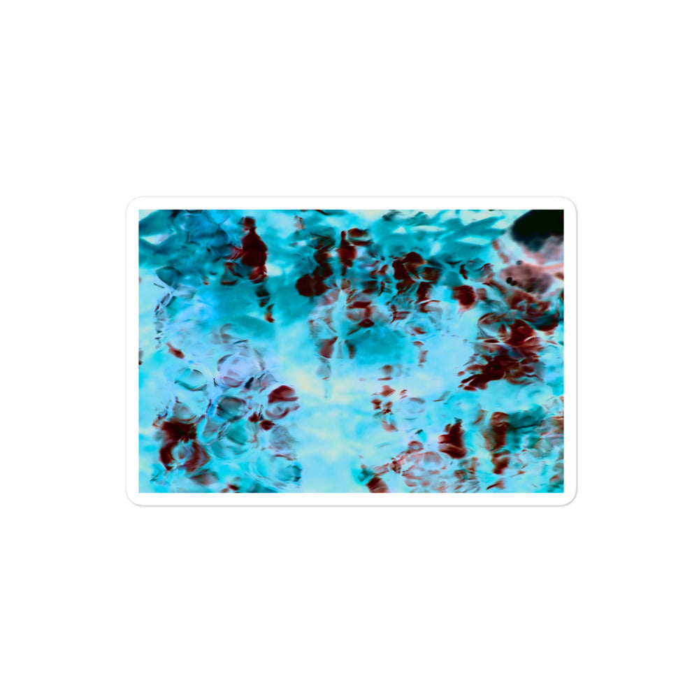 A medium rectangular vinyl sticker with an image of a vivid blue and red water reflection design.