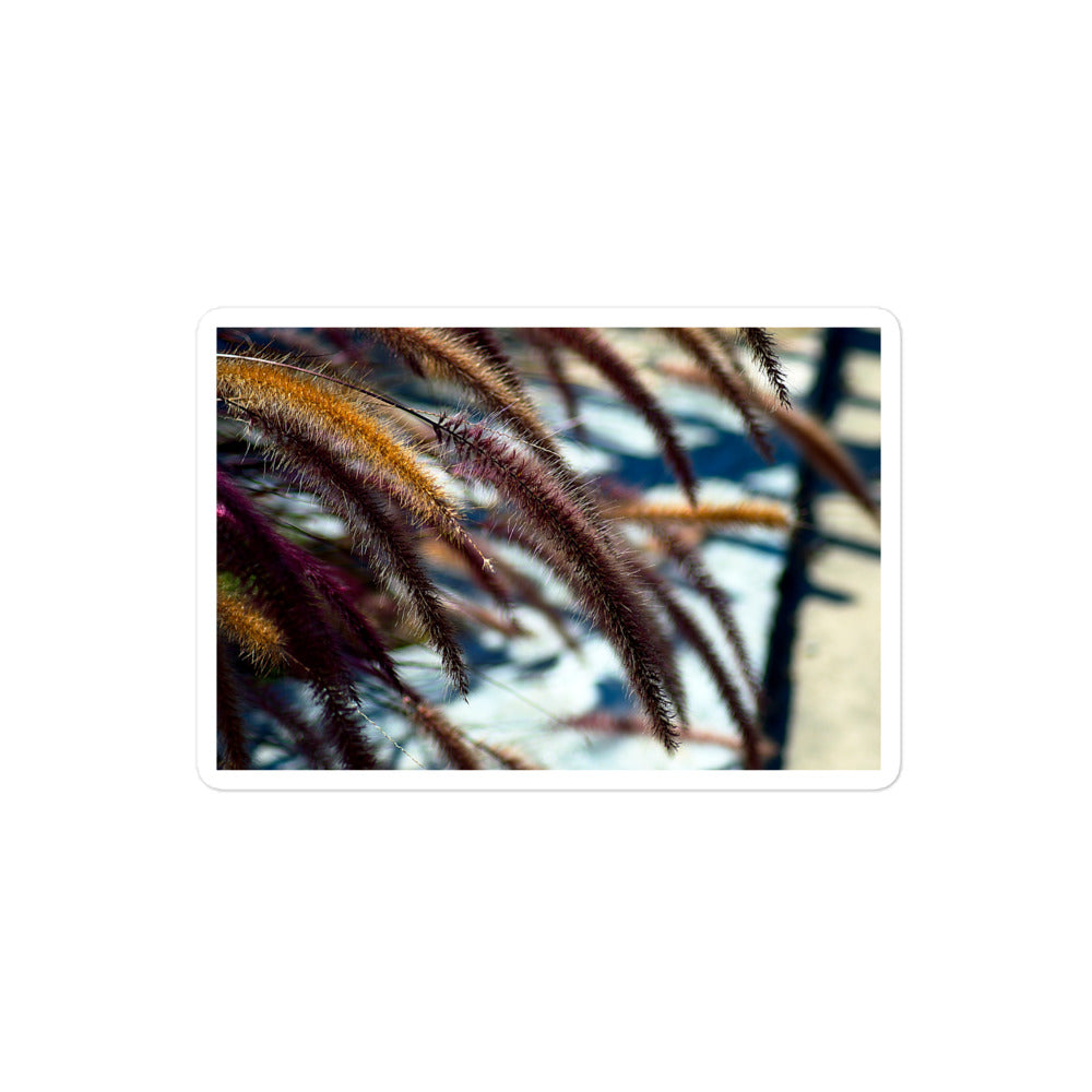 A medium rectangular vinyl sticker with an image of yellow and purple foxtails.