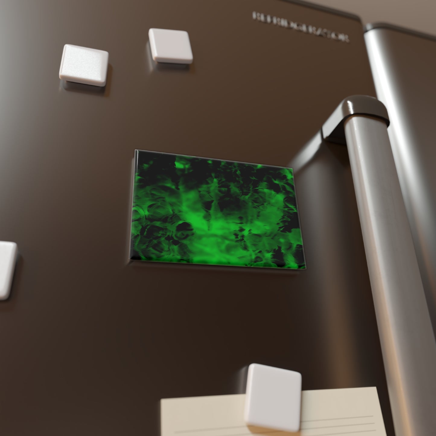Lifestyle photo of a rectangular button magnet with an image of a vivid green and black water reflection design, placed on a fridge.