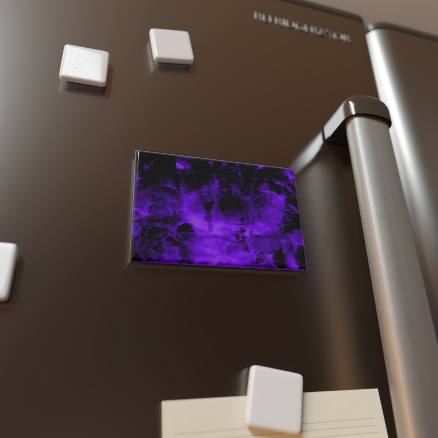 Lifestyle photo of a rectangular button magnet with an image of a vivid purple and black water reflection design, placed on a fridge.