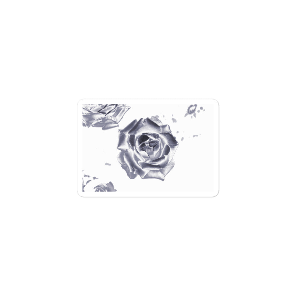 A small rectangular vinyl sticker with an image of a reflective silver rose design.