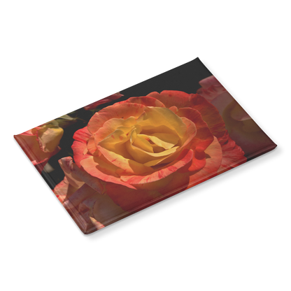 Close-Up_of_Warm_Sunset_Rose_Rectangula_RectangleButtonMagnet_H_Angle_Mockup.png