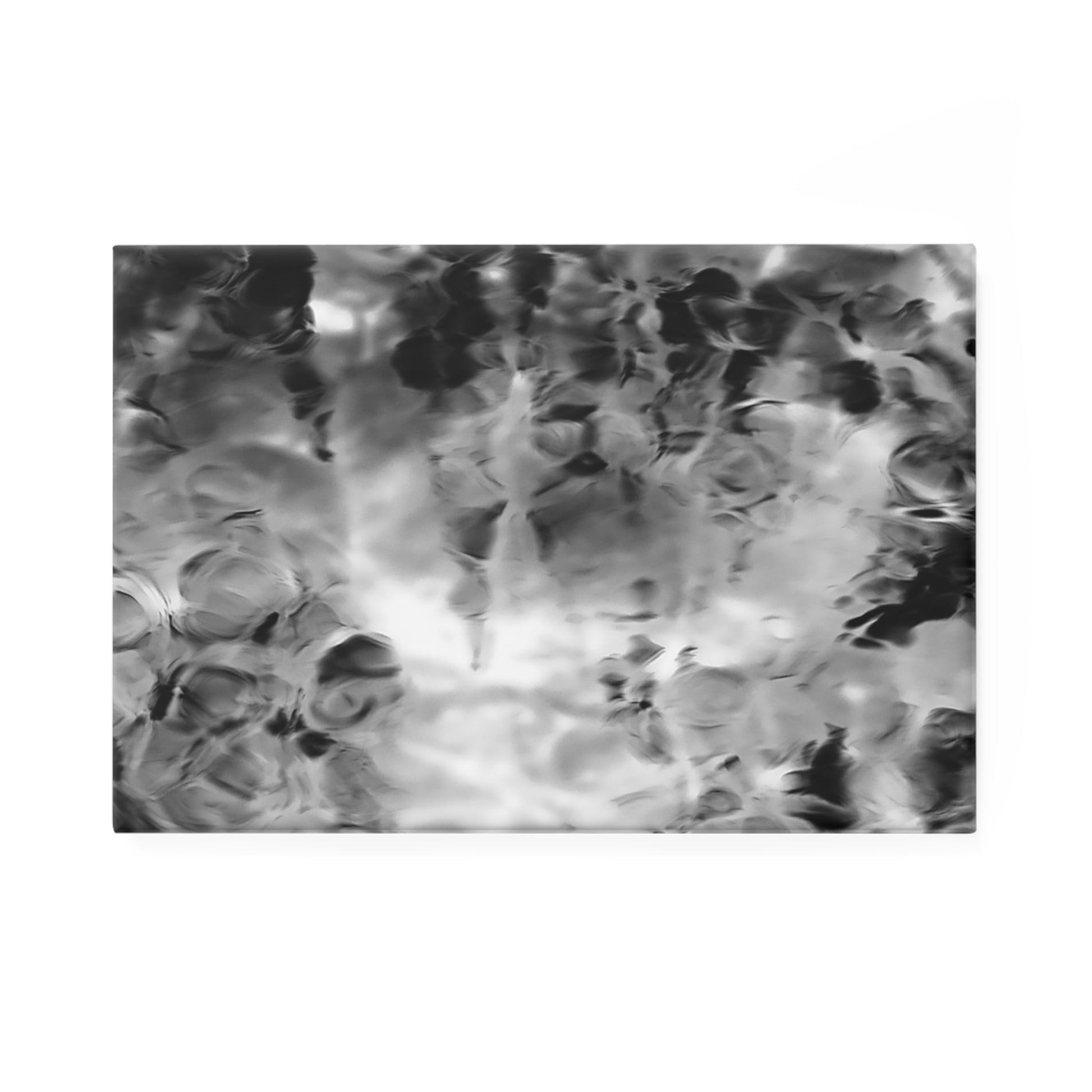 A rectangular button magnet with an image of a vivid black and white water reflection design.