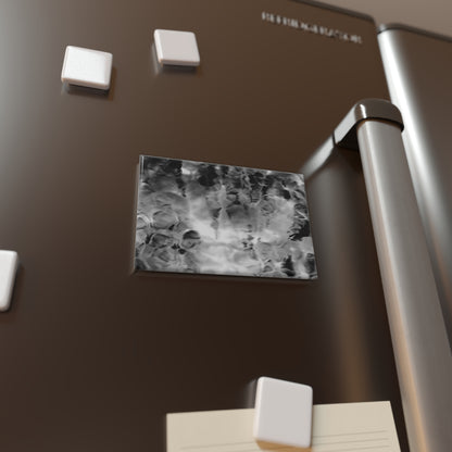 Lifestyle photo of a rectangular button magnet with an image of a vivid black and white water reflection design, placed on a fridge.