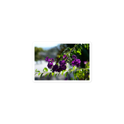 A small rectangular vinyl sticker with an image of purple flower blooms in a tree.