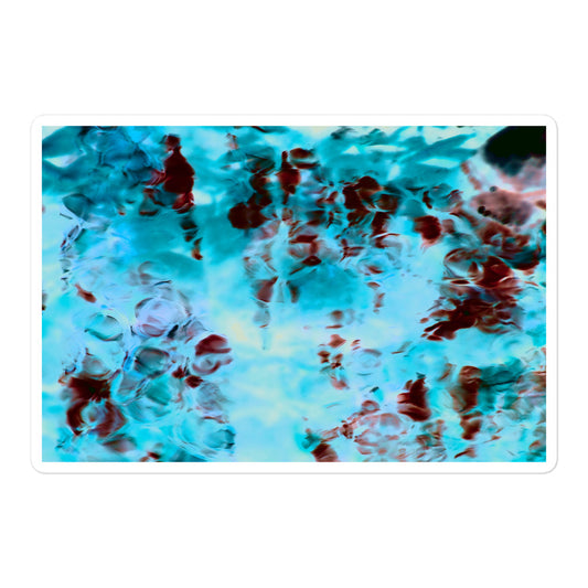A large rectangular vinyl sticker with an image of a vivid blue and red water reflection design.