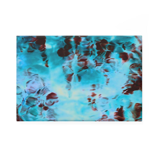A rectangular button magnet with an image of a vivid blue and red water reflection design.