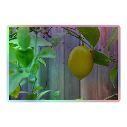 A large rectangular holographic sticker with an image of a bright yellow lemon with green leaves and a wooden fence in the background.