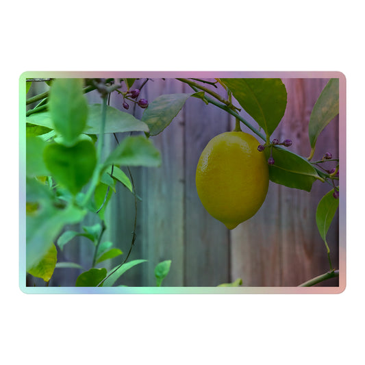 A large rectangular holographic sticker with an image of a bright yellow lemon with green leaves and a wooden fence in the background.