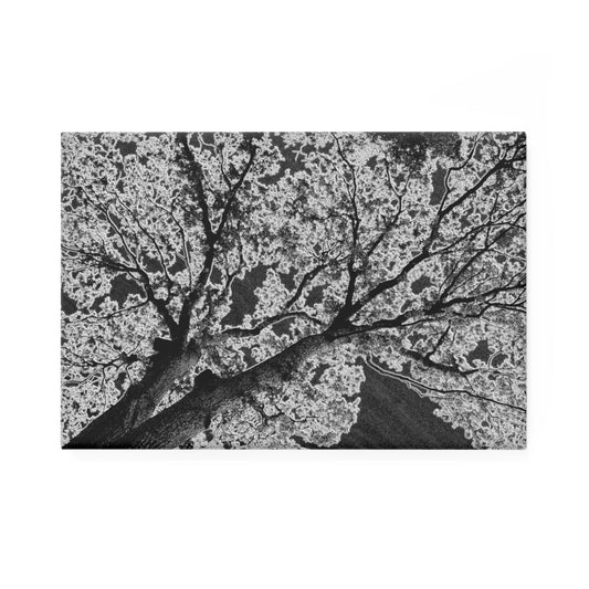 A rectangular button magnet with an image of a dark embossed tree design with lightning like features.