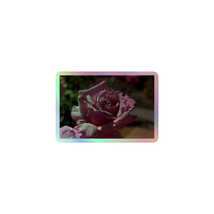 A small rectangular holographic sticker with a close up image of a light pink rose bloom.