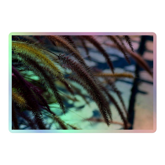 A large rectangular holographic sticker with an image of purple and yellow foxtails in front of a blurred grey background.