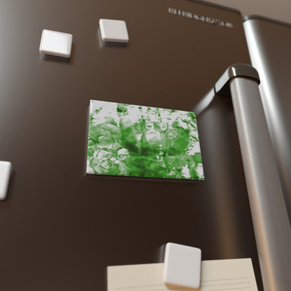 Lifestyle photo of a rectangular button magnet with an image of a vivid green water reflection design, placed on a fridge.