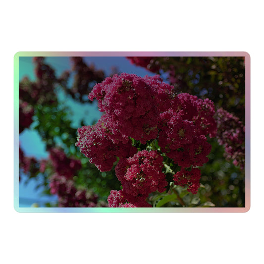 A large rectangular holographic sticker with an image of bright pink crape myrtle blooms with green leaves and blue sky in the background.