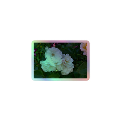 A small rectangular holographic sticker with an image of a cluster of white roses with dark green leaves.